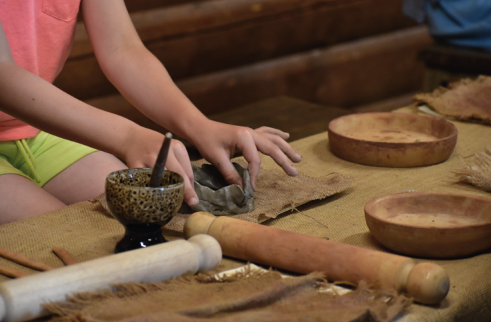 A child making a clay model in the Longhouse craft room, WWT Martin Mere
